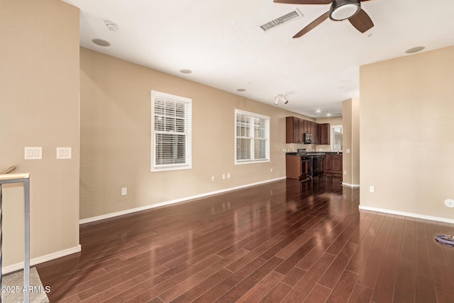 unfurnished living room with dark hardwood / wood-style floors and ceiling fan