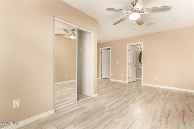 unfurnished bedroom with ceiling fan, a closet, and light hardwood / wood-style flooring