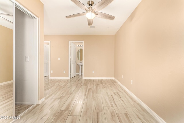 empty room featuring ceiling fan and light hardwood / wood-style flooring