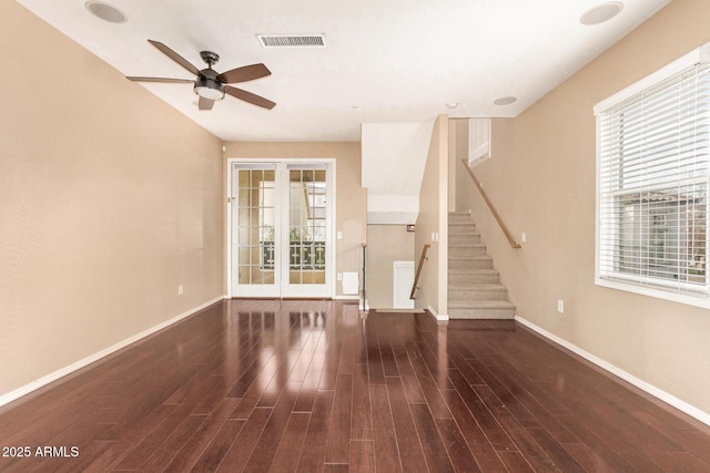 unfurnished living room featuring ceiling fan, dark hardwood / wood-style flooring, and french doors