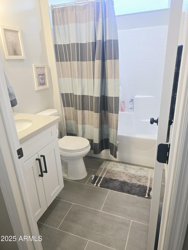 full bathroom featuring shower / tub combo, vanity, toilet, and tile patterned floors