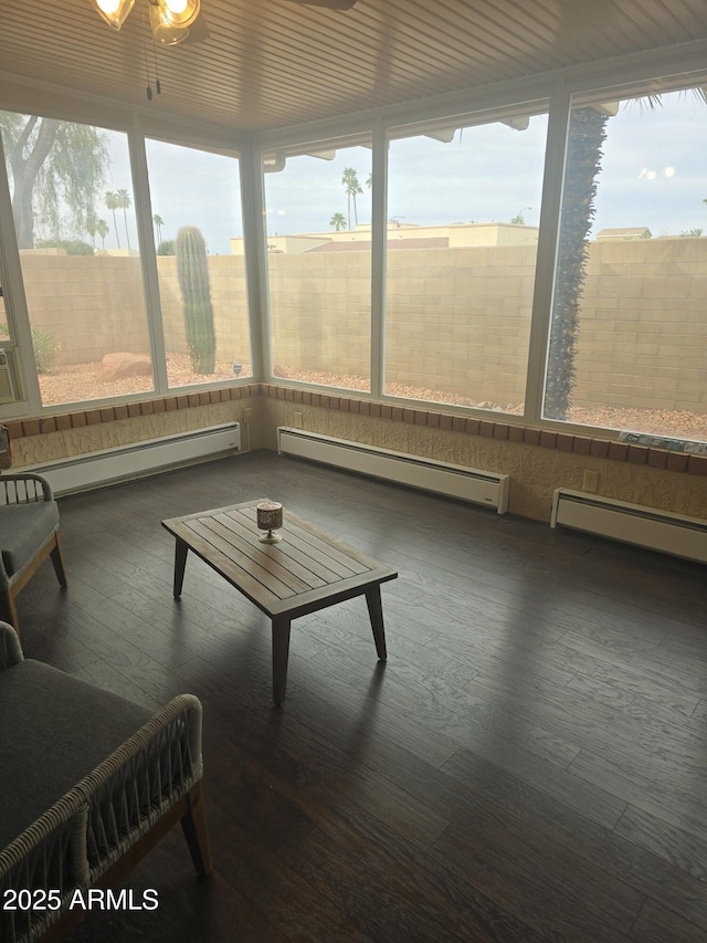 unfurnished sunroom with a baseboard heating unit