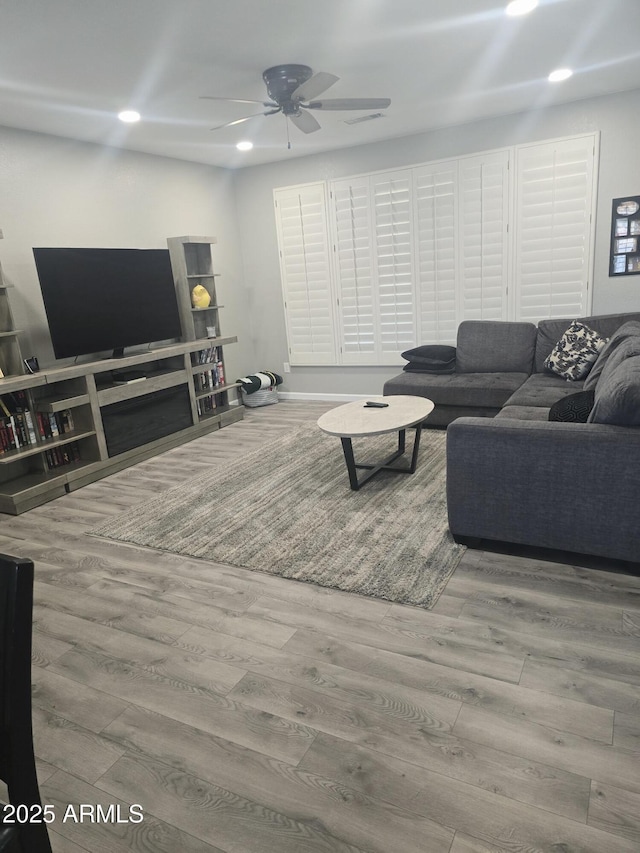 living room featuring ceiling fan, wood finished floors, and recessed lighting