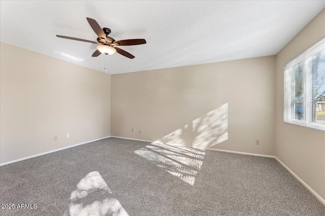 carpeted spare room with ceiling fan and a textured ceiling