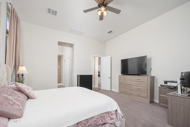 bedroom with light carpet, a ceiling fan, visible vents, and baseboards