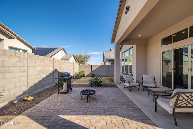 view of patio / terrace with a fire pit, grilling area, and a fenced backyard