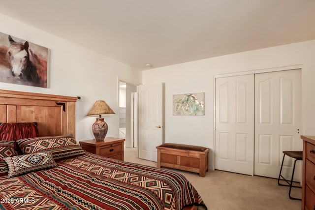 bedroom featuring a closet and light colored carpet