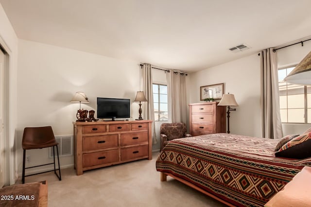 bedroom with visible vents and light colored carpet