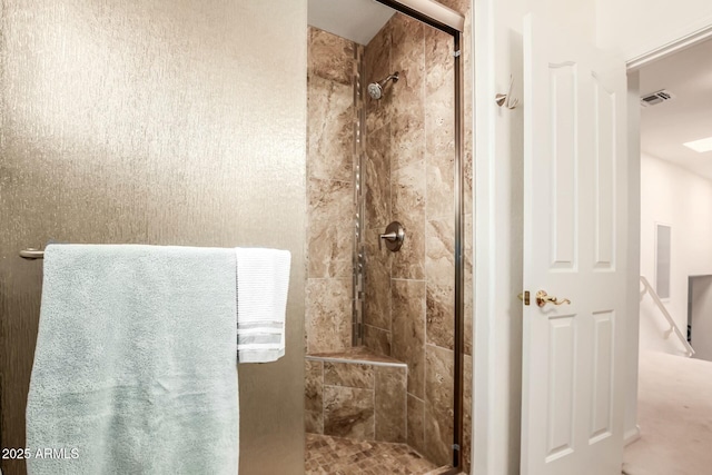 bathroom with a stall shower and visible vents