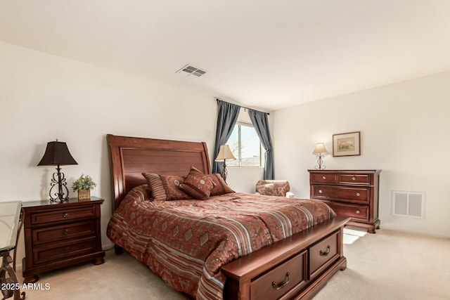 bedroom with visible vents and light colored carpet