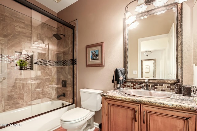 bathroom with enclosed tub / shower combo, vanity, toilet, and decorative backsplash