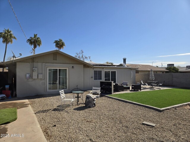 wooden deck featuring a yard, outdoor lounge area, and a fenced backyard