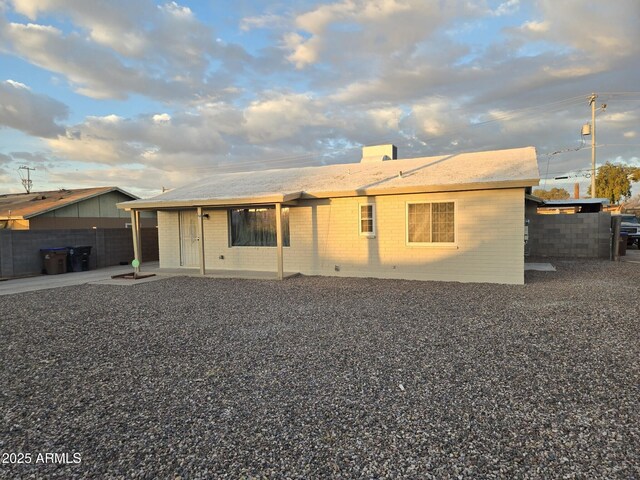 rear view of property featuring a yard, a patio, outdoor lounge area, and a fenced backyard