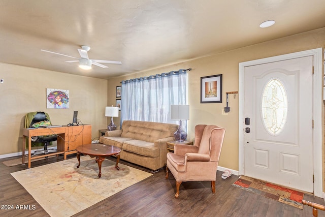 living room with ceiling fan, baseboards, and dark wood-style floors