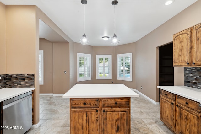 kitchen featuring backsplash, dishwasher, pendant lighting, and light countertops