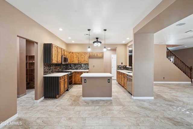 kitchen with backsplash, a center island, decorative light fixtures, light countertops, and appliances with stainless steel finishes