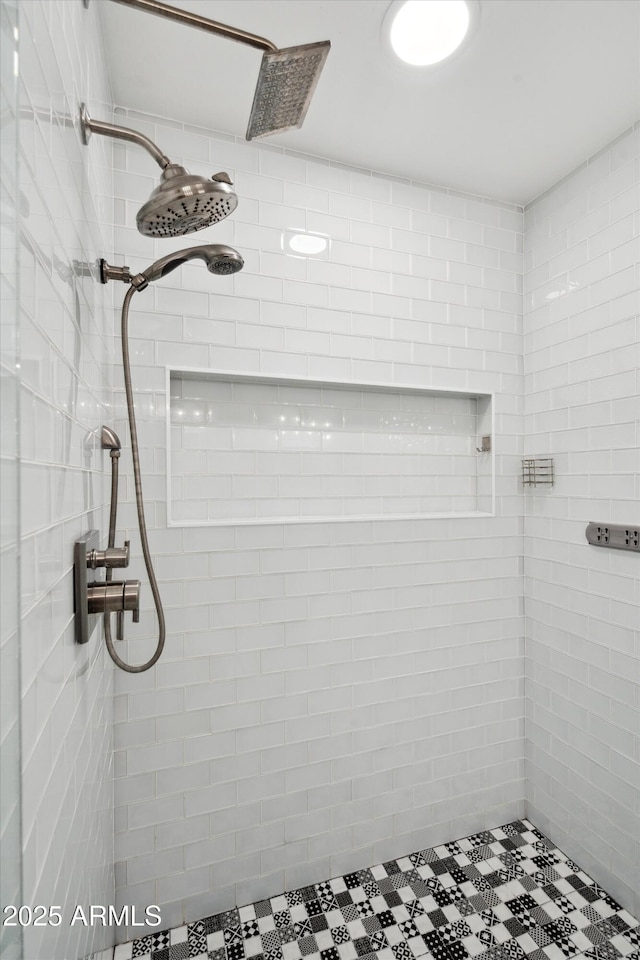 bathroom with a tile shower