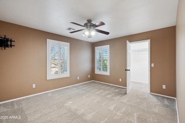 spare room with visible vents, baseboards, ceiling fan, and carpet flooring