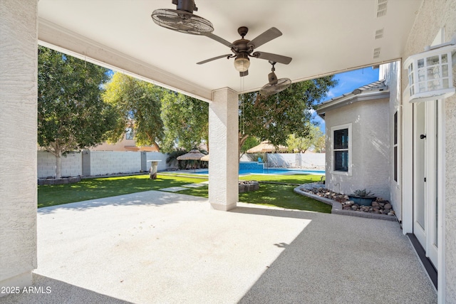 view of patio featuring a fenced backyard, a fenced in pool, and ceiling fan