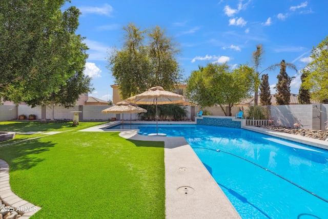 view of pool featuring a fenced in pool, a fenced backyard, and a lawn