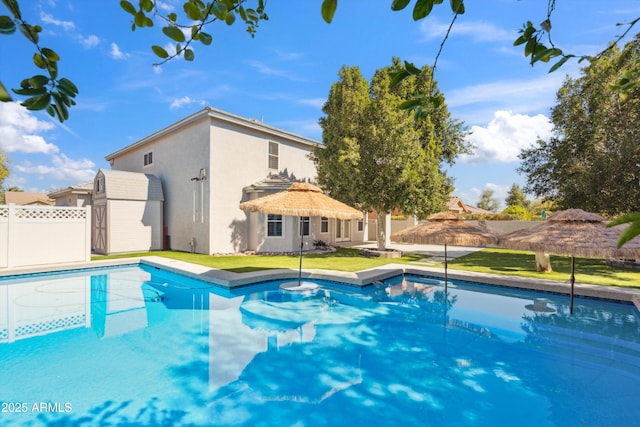 view of pool featuring a yard, a fenced in pool, and fence