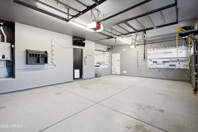 garage featuring a garage door opener and baseboards