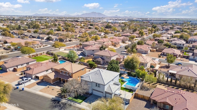 birds eye view of property with a mountain view and a residential view