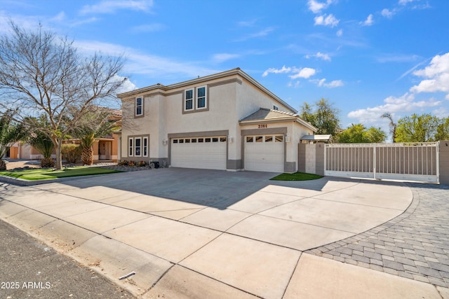 view of front facade featuring concrete driveway, fence, and stucco siding