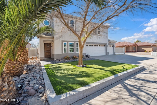 view of front of home with stucco siding, an attached garage, driveway, and fence