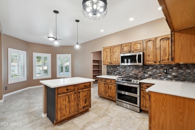 kitchen with brown cabinets, tasteful backsplash, a center island, appliances with stainless steel finishes, and light countertops