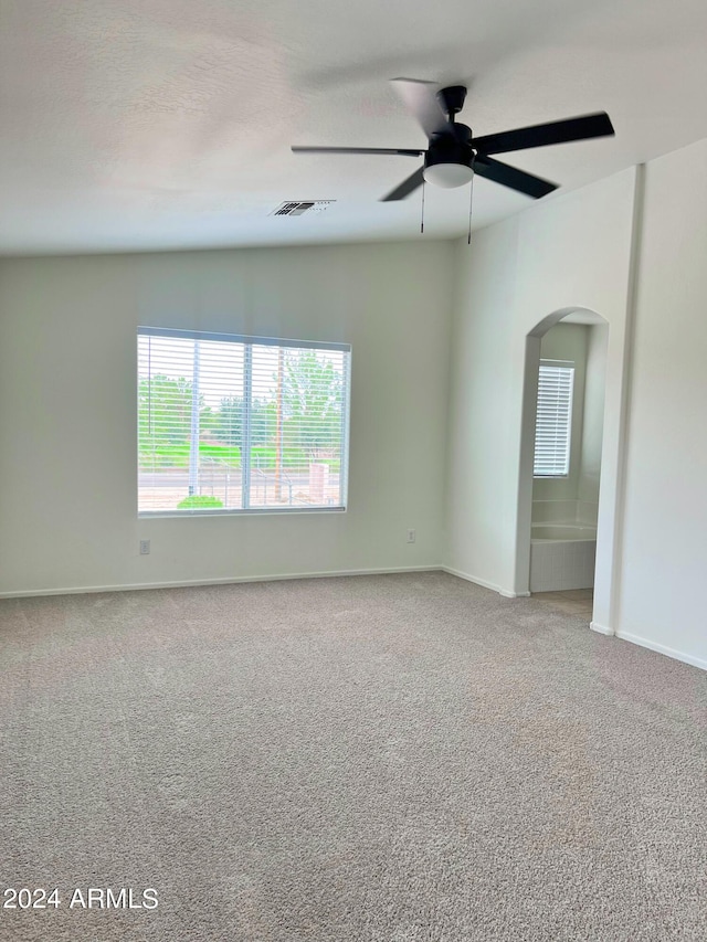 empty room with ceiling fan and carpet flooring