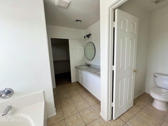 bathroom featuring tile patterned flooring, vanity, and toilet