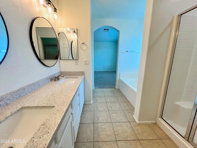 bathroom featuring tile patterned flooring, vanity, and separate shower and tub