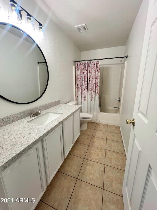 full bathroom with tile patterned flooring, vanity, toilet, and shower / bath combo with shower curtain