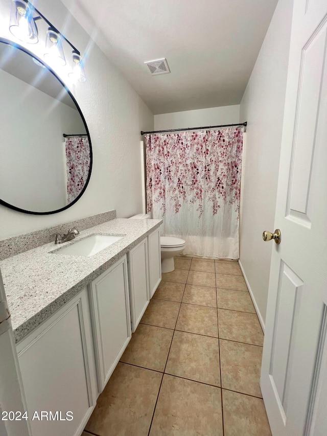 bathroom with tile patterned floors, toilet, and vanity