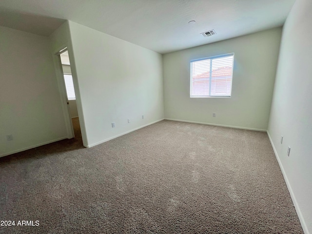 unfurnished room featuring carpet