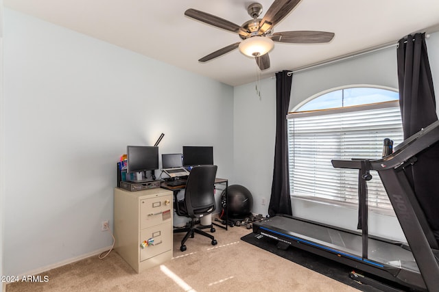 carpeted office space with ceiling fan