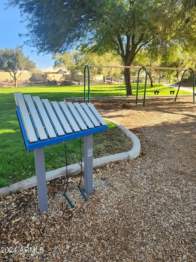 view of property's community featuring a playground and a yard