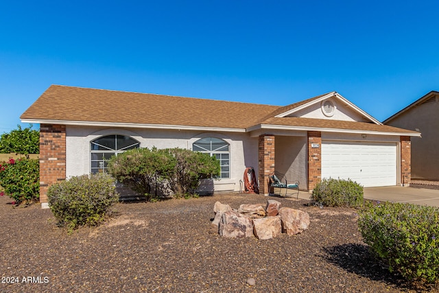 ranch-style home featuring a garage