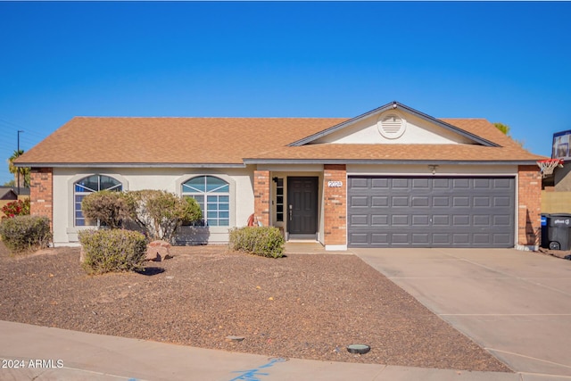 ranch-style house featuring a garage