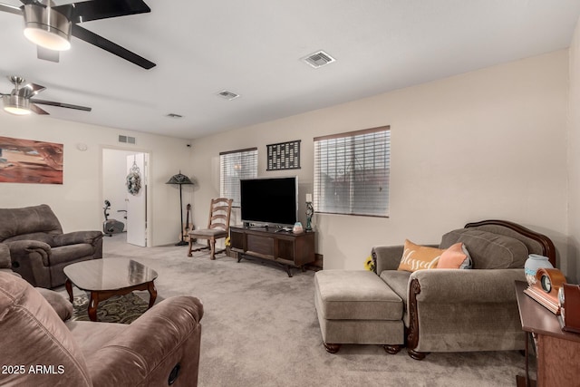 living room with light carpet, ceiling fan, and visible vents