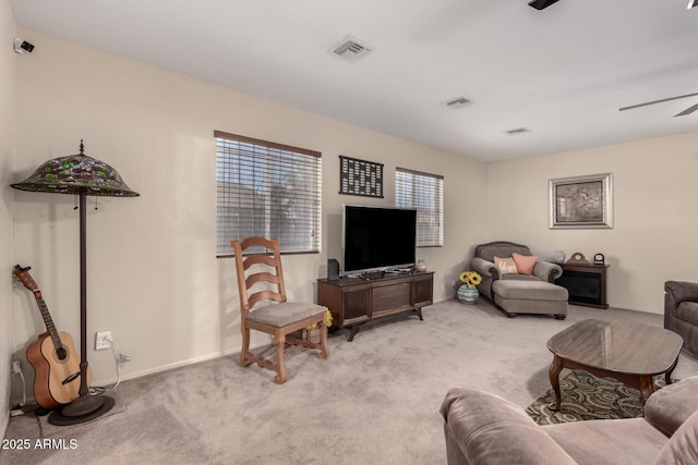 living room featuring light carpet, ceiling fan, and visible vents