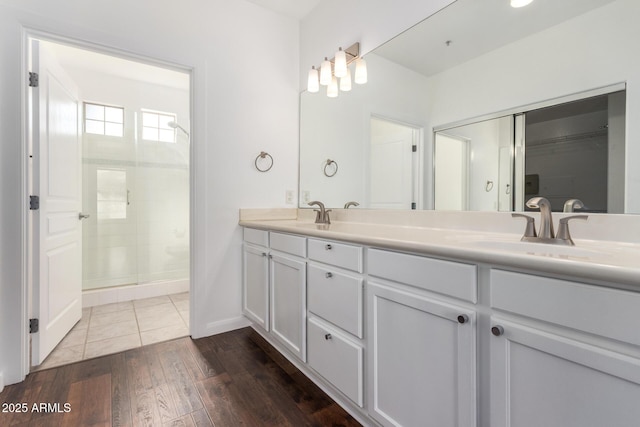 bathroom featuring vanity, an enclosed shower, and wood-type flooring