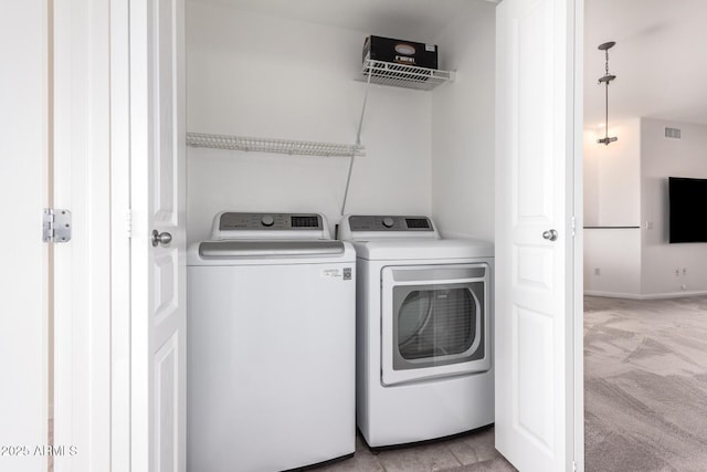 washroom featuring separate washer and dryer and light colored carpet