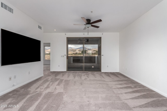 unfurnished living room featuring light colored carpet and ceiling fan