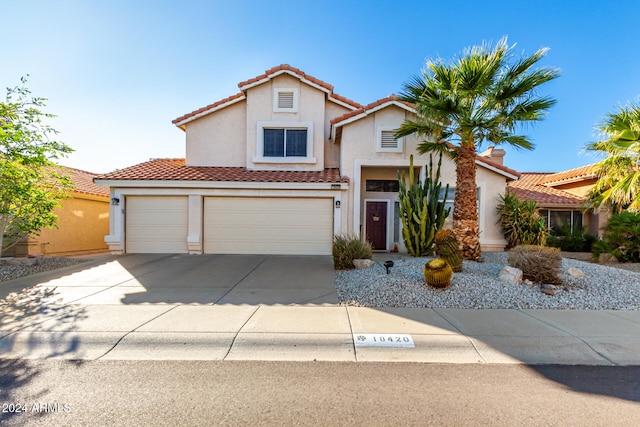 mediterranean / spanish-style home with a garage