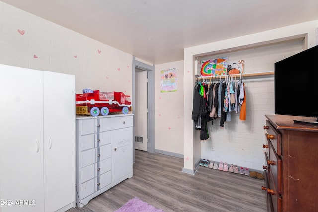 bedroom with a closet and light hardwood / wood-style floors