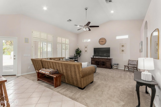 living area featuring light tile patterned floors, visible vents, and a healthy amount of sunlight