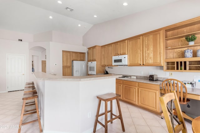 kitchen featuring white appliances, light countertops, a kitchen island, and open shelves