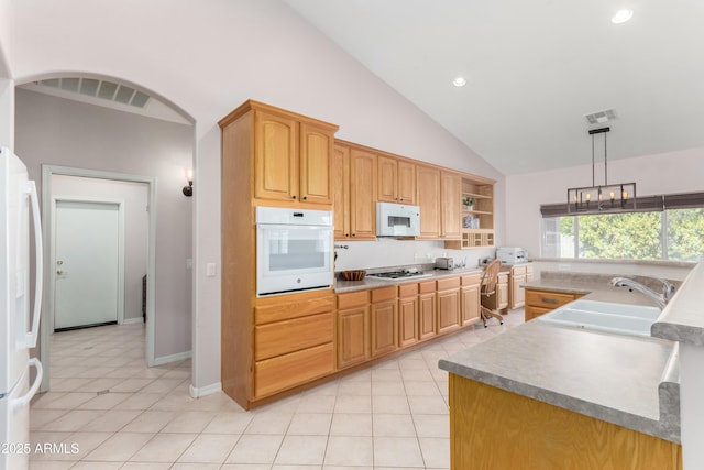 kitchen featuring white appliances, visible vents, light countertops, and a sink